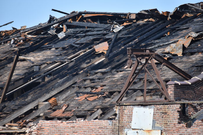 The fire left the building’s roof a charred skeleton (Photo by Steve Koepp)