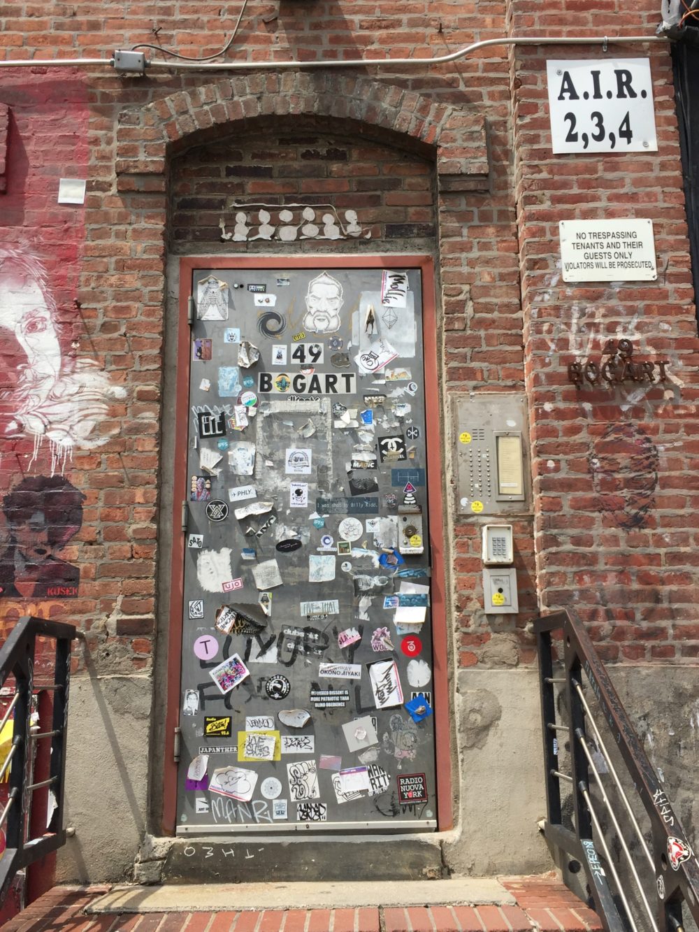 The famous sticker-covered front door of the building housing ConsenSys in East Williamsburg (Photo by Steve Koepp)